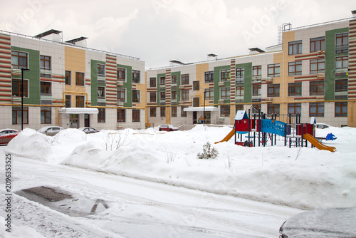 Modern apartment complex with playground winter