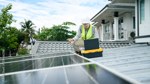 Asian Engineer Inspecting Solar Panels on Residential Rooftop with Laptop and Toolbox
