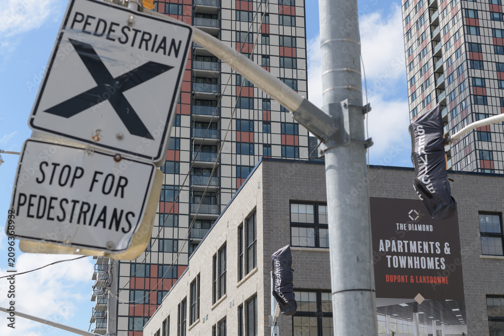 Obraz premium traffic signs and banner of The Diamond, an apartment building complex located at 950 Lansdowne Av, Toronto
