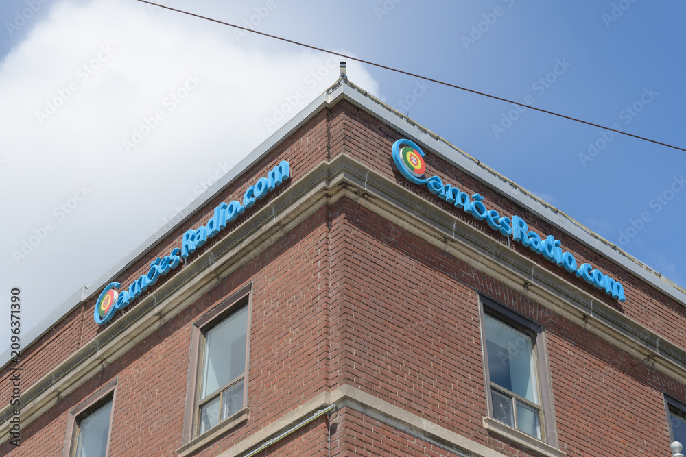 Obraz premium building sign on the exterior of Camões TV, a television studio, a Portuguese-language media org located at 722 College St, Toronto