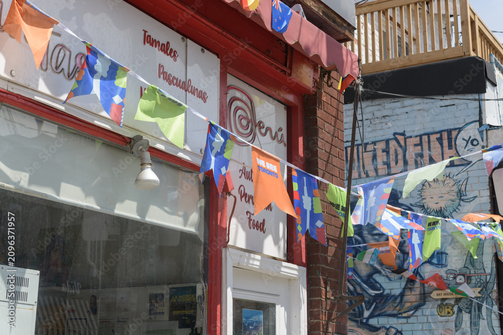 Obraz premium FIFA World Cup bunting with flags outside Latin Taste, a Peruvian restaurant, located at 200 Baldwin St, Kensington Market, Toronto