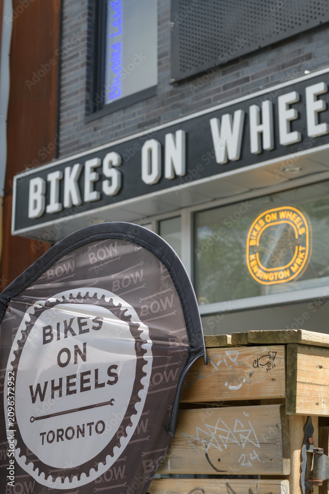 Obraz premium exterior building facade and signage of Bikes on Wheels, bicycle shop, located at 299 Augusta Av, Kensington Market, Toronto