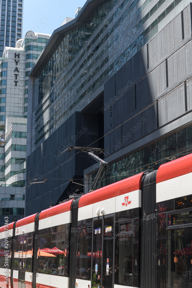 Obraz premium trolley running on King St W with view of the Hyatt Regency, a hotel, located at 370 King St W, Toronto