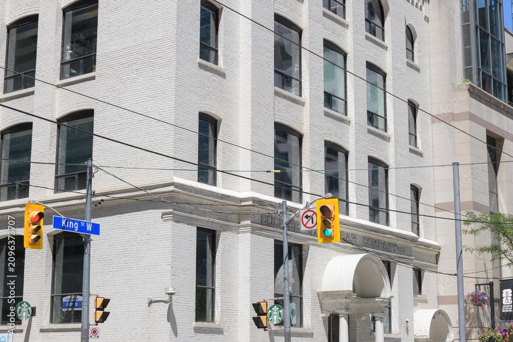 Obraz premium Starbucks coffee signs outside 322 King St W, the 1903 Eclipse Whitewear Building, a former underwear factory, Toronto