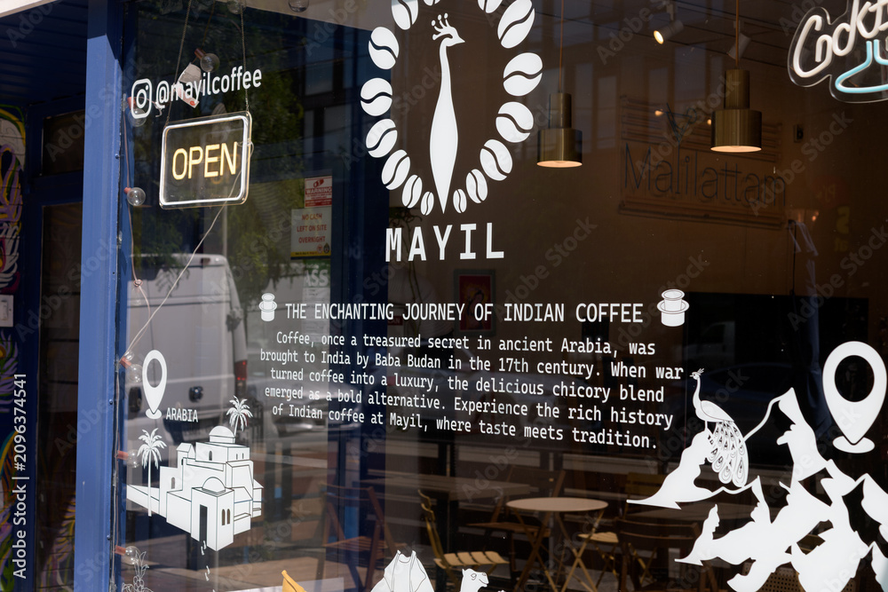 Obraz premium vinyl window sign and text at Mayil Coffee, a coffee shop, located at 870 College St, Toronto