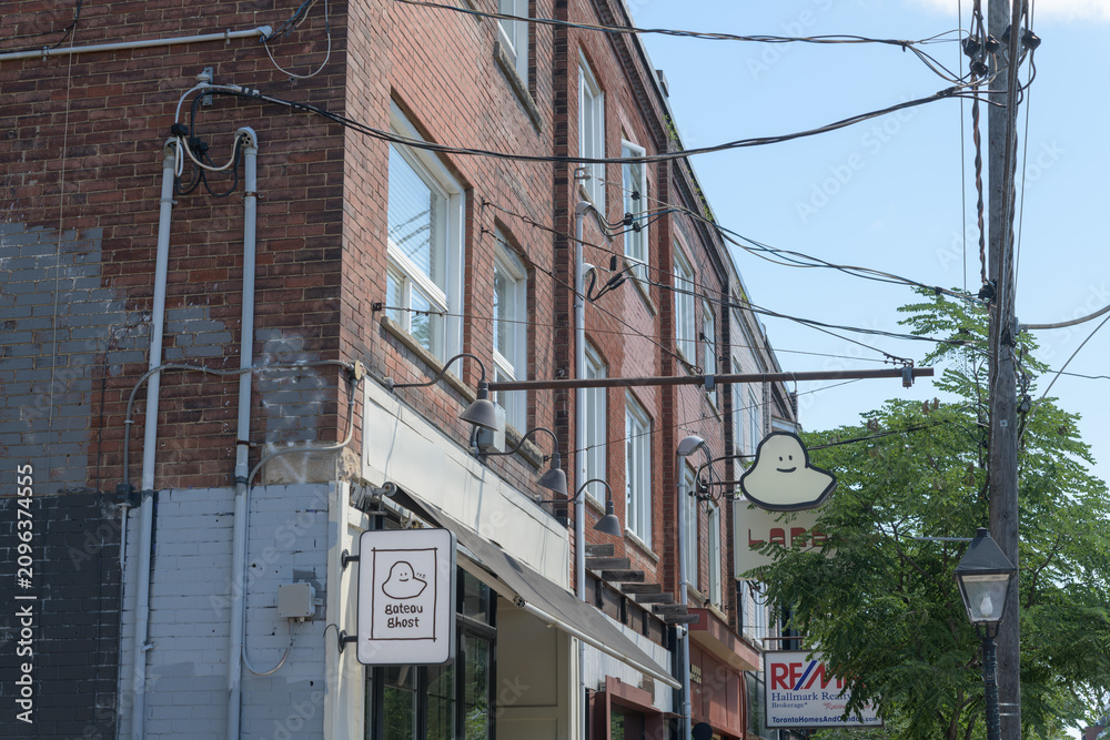 Obraz premium exterior signage outside Gateau Ghost, a restaurant, located at 974 College St, Toronto