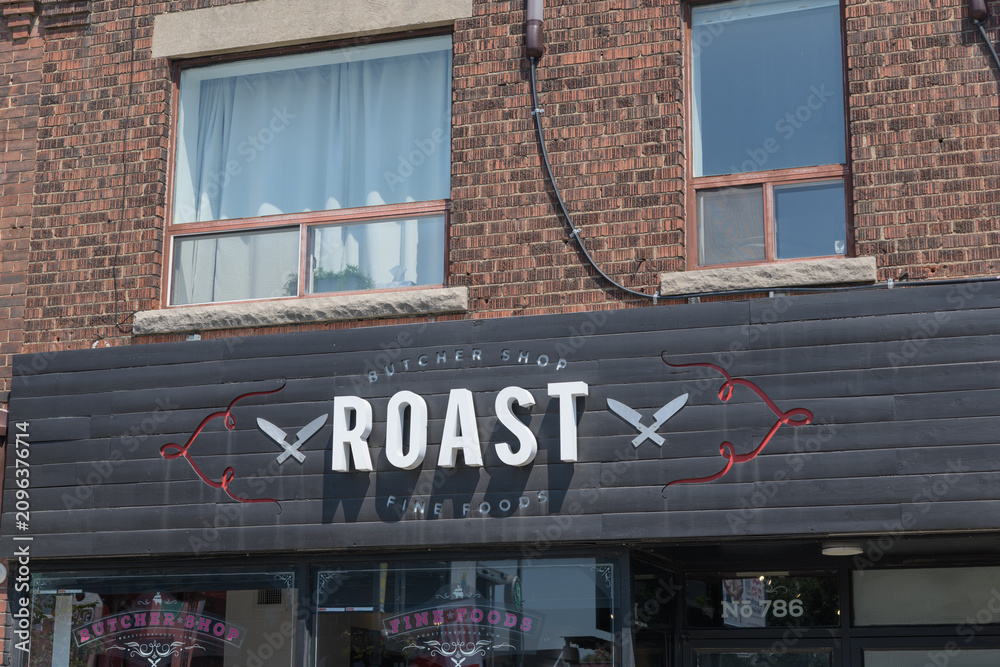 Obraz premium exterior building facade and sign of Roast Fine Foods, a butcher shop, located at 786 St Clair Av W, Toronto
