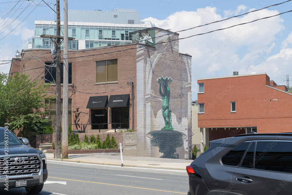 Obraz premium trompe du l’œil mural on the east facing wall of 314 Davenport Rd featuring a standing cherub statue-bird bath or fountain set in an architectural niche, Toronto
