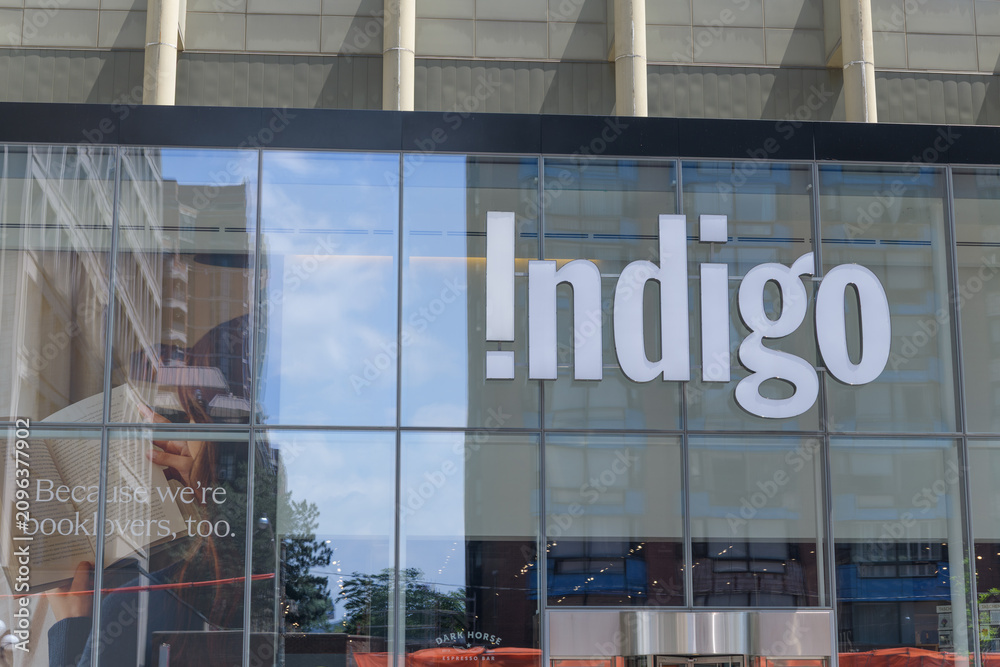 Obraz premium exterior building facade and sign of Indigo, a book store chain, located here at 55 Bloor St W inside Manulife Centre (Bay St side), Toronto