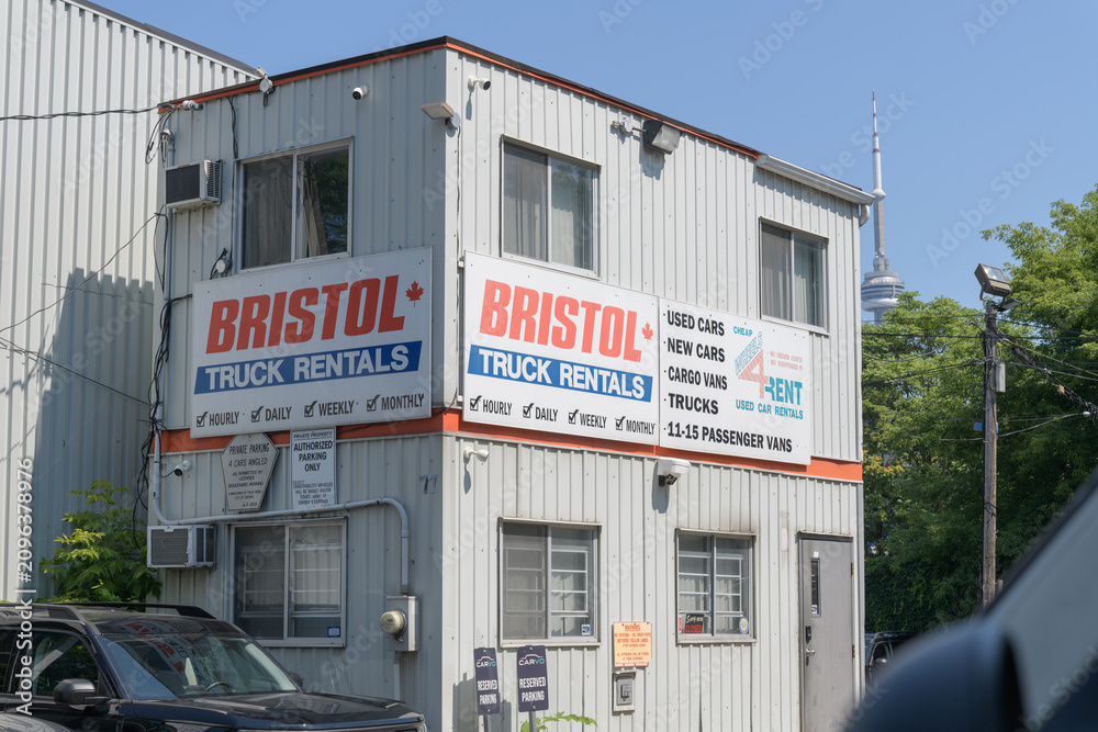 Fototapeta premium old building with signs at Bristol Car and Truck Rental Toronto (79 Nassau St, near Kensington Market)