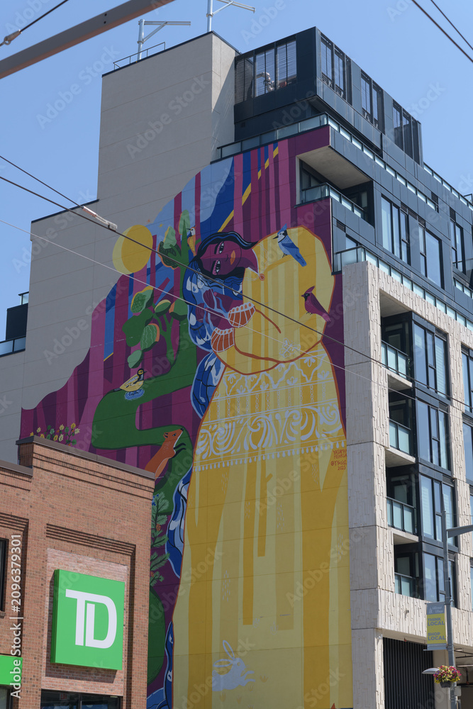 Obraz premium exterior building and corporate logo sign outside a TD bank branch located at 870 St Clair Av W; and huge mural art by Yasaman Mehrsa called 