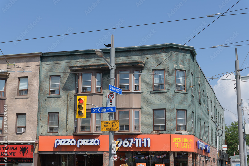 Obraz premium apartment and commercial block and location of Pizza Pizza, 950 St Clair Av W at Oakwood, Toronto