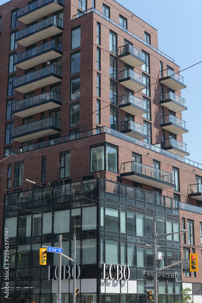 Fototapeta premium exterior view of building known as 900 St Clair West, a condominium complex, and the location of LCBO, a liquor store chain, Toronto