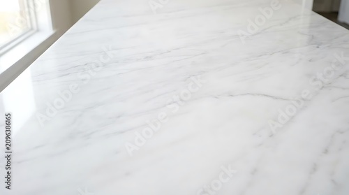 Clean white marble surface with subtle grey veining near window