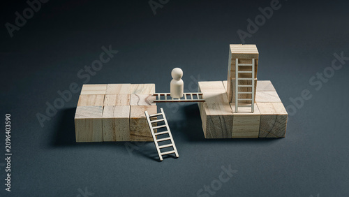 Obraz na płótnie Wooden figure choosing between bridge and ladder to overcome obstacle and reach