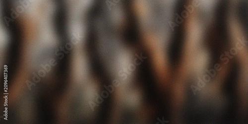 Abstract dark blurred background with soft vertical light, warm brown and neutral tones, moody atmospheric texture, elegant modern backdrop for design, wallpaper and creative projects