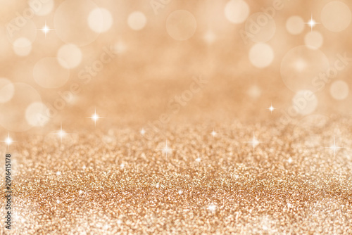 Golden glitter background with soft bokeh and sparkling light for festive design