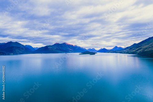 Konstfotografi Sunrise over mountains by a lake