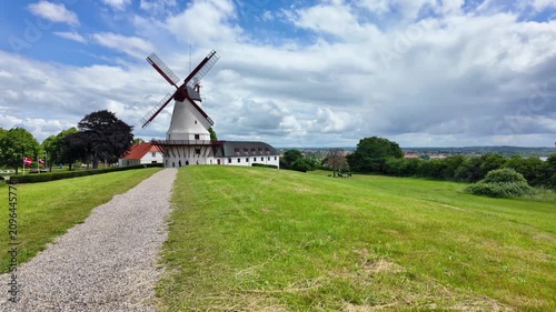 Historic Dybbol Mill on the Duppel Redoubts near Sonderborg, Denmark beneath a blue sky with impressive clouds and open countryside.