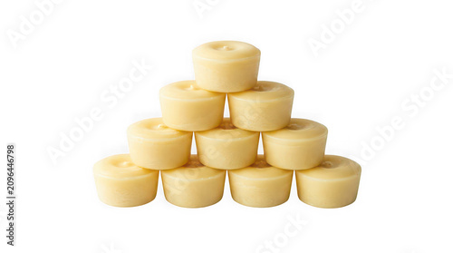 Pyramid stack of small round wax tealight candles isolated on transparent background.