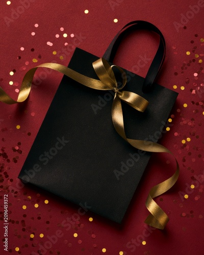 Flat Lay Top View of a Black Shopping Bag with Gold Accents
