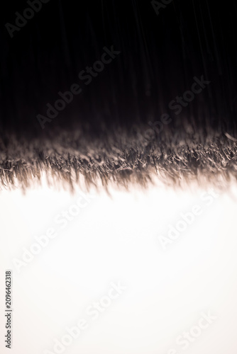 Paintbrush bristles macro closeup view white background. Abstract texture shot emphasizing fine art craft tools creative studio supplies commercial presentation design branding materials marketing cam