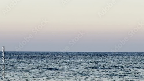 Public beach, summer, beautiful sunny weather. Picturesque beach, waves crashing on the sandy shore.