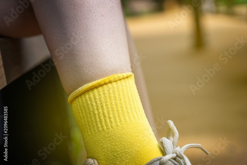 Bild auf Leinwand Yellow sock on a teenager's foot with a folded elastic band