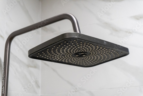 Bild auf Leinwand Closeup of black showerhead in modern bathroom
