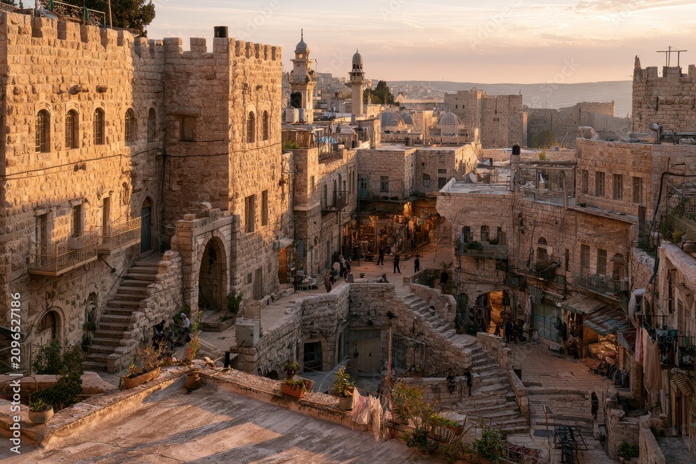 Fototapeta premium Golden hour view over the old city of Hebron from a rooftop beside a historic mosque
