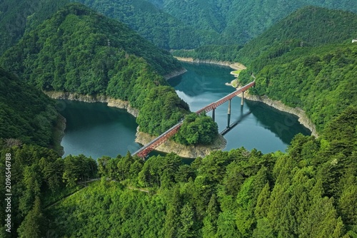 Canvas Print Aerial drone photo of Setsugoko Lake and red railway bridge in Oku-Oi, Shizuoka,