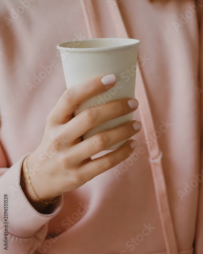 Woman Hand Holding Blank White Paper Cup in Pink Outfit