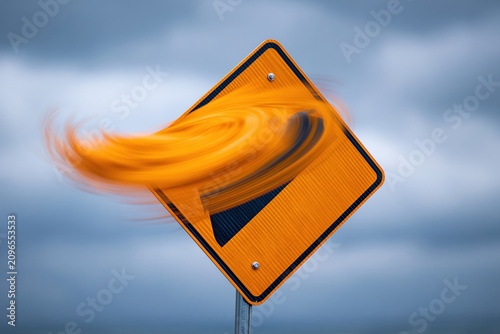 Blurred Orange Warning Sign in Strong Wind