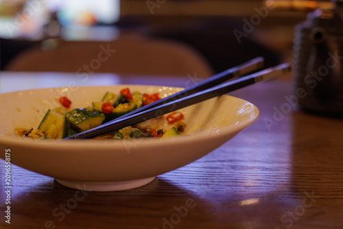 Принти на полотні Freshly prepared salad awaits eager taste buds in a cozy restaurant setting