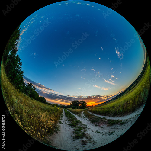 Fisheye view of picturesque countryside landscape with rising sun over meadow and country roads. Photo in Fulldome HDR format for planetarium use, taken through a circular lens