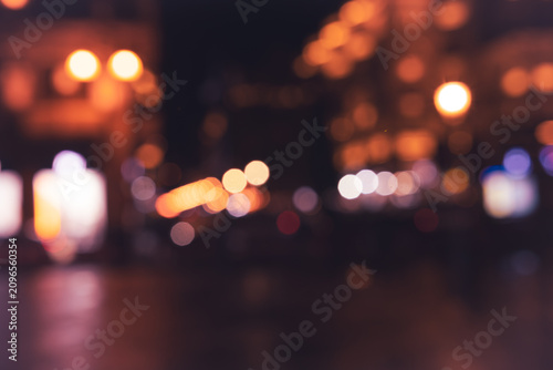 Φωτογραφία City lights dance in the night sky while people stroll through a vibrant urban l