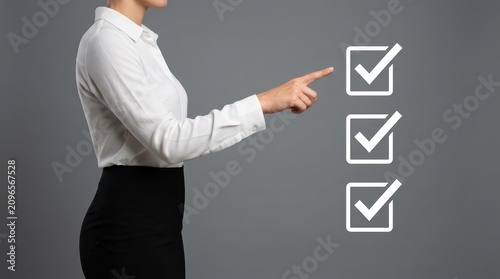 Woman pointing at check marks for confirmation and checking.
