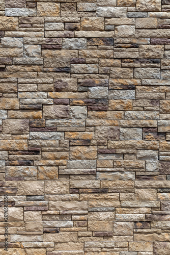 Full frame abstract texture background of a of a ledgerstone style brick wall, with natural stone in different shapes and sizes