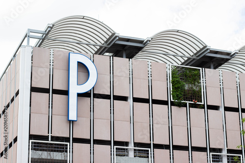 Bild auf Leinwand Modern parking garage exterior featuring large illuminated letter P signage and