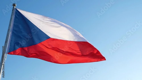 National flag of the czech republic waving against a clear blue sky