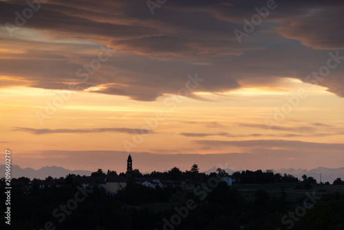 Dramatic Summer Sunset Over Rural Village in Piedmont, Italy With Distant Alps