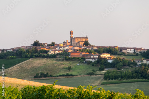 Historic Hilltop Village with Church and Clock Tower in Piedmont, Italy, Surrounded by Vineyards