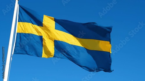 Flag of sweden waving against a clear blue sky