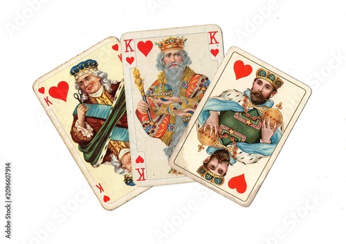 Photography A hand of three vintage picture playing cards in different designs isolated on a white background