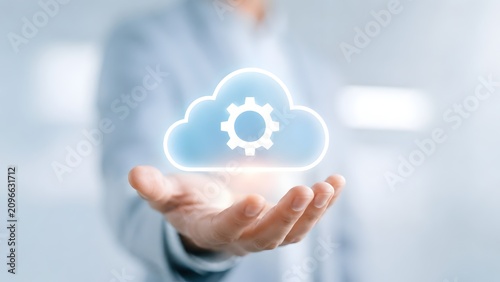 Human hand holding a glowing cloud icon with a gear symbol inside, representing cloud computing services, IT solutions, and data management systems.