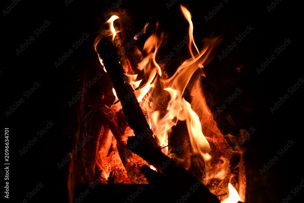 Fototapeta premium fire flames with sparks on a black background, close-up