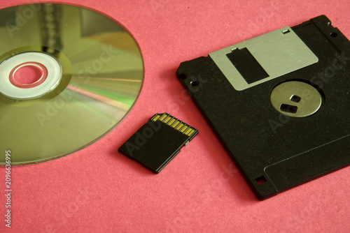 Fotografie Representing the evolution of digital storage with cd-rom, sd card, and floppy d