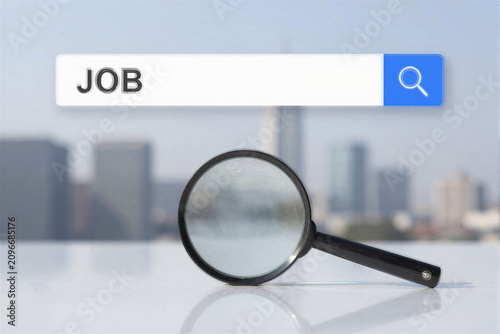 Job search with magnifying glass and city background