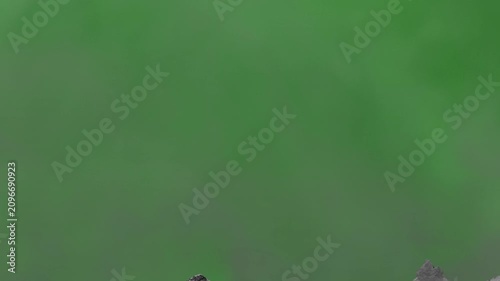 Crack in a cement wall. Intro with destruction. Broken wall. Concrete wall destruction. Animation of a concrete wall destruction with dust against a green screen background. Concrete explosion.