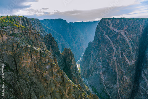 Bild auf Leinwand Deep dark gorge of Black Canyon plunges to the Gunnison River far below between sheer schist walls, Black Canyon of the Gunnison NP, Colorado